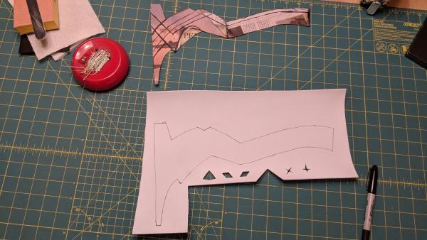 The first trim piece traced out beside the original paper template